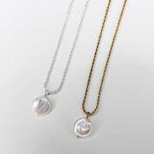 Load image into Gallery viewer, Two Coin Pearl Pendant necklaces, one crafted in 14K gold fill and the other in sterling silver, displayed on a plain white background. Each necklace features a round, iridescent coin pearl pendant with a subtle, natural texture.